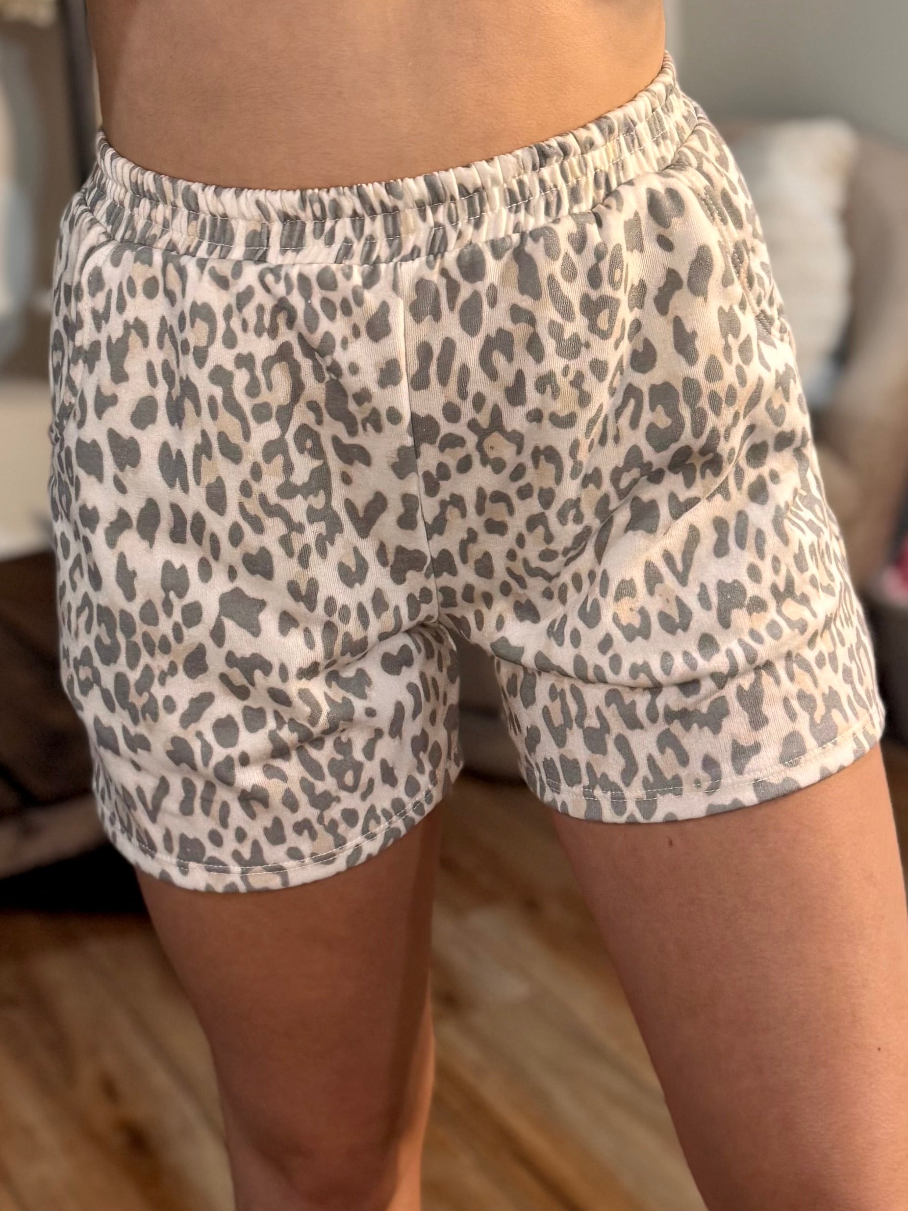Person wearing leopard print shorts elastic waist Terry knit