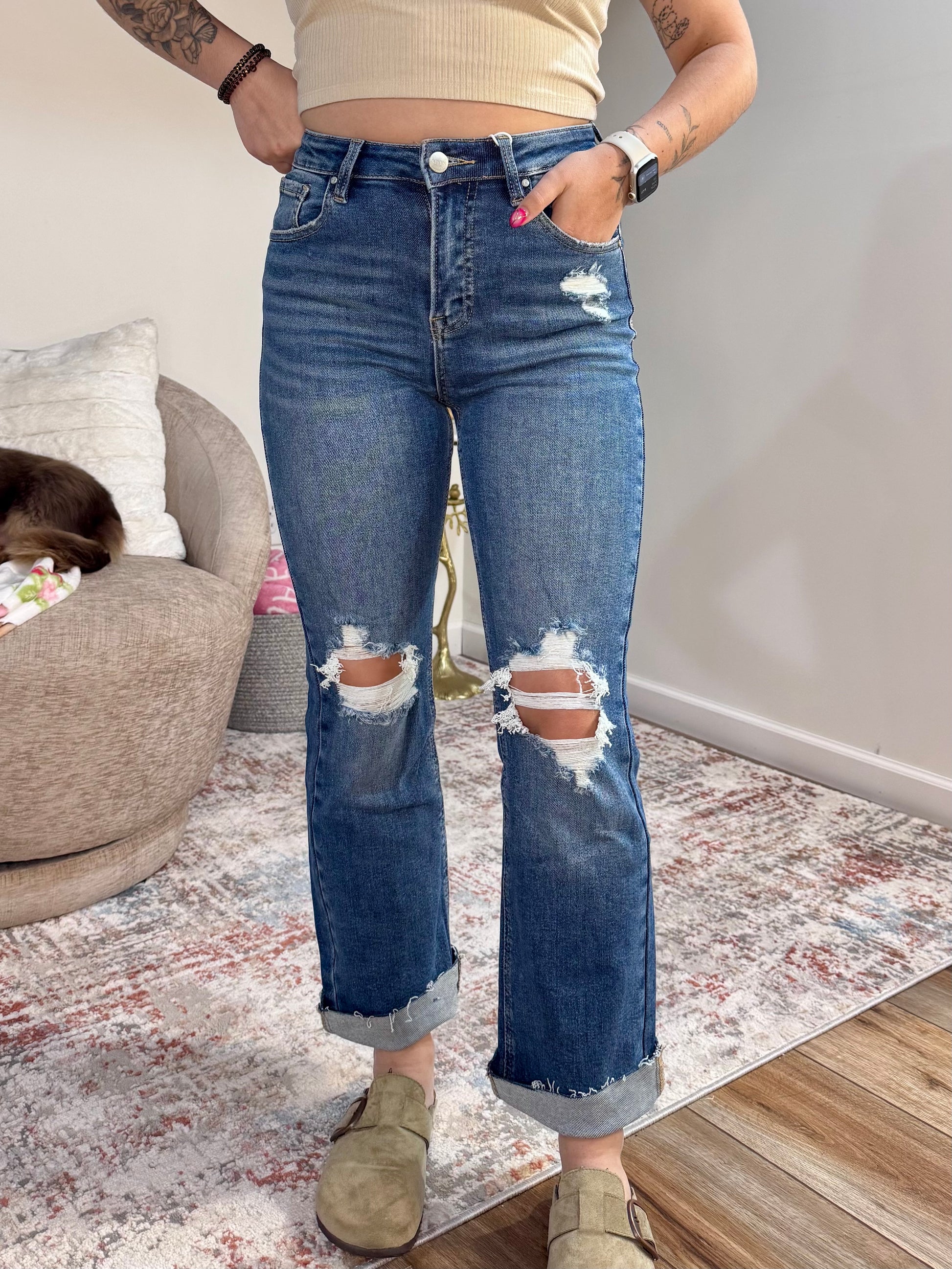 High rise straight leg jeans with knee distressing and raw hem. Stretch denim