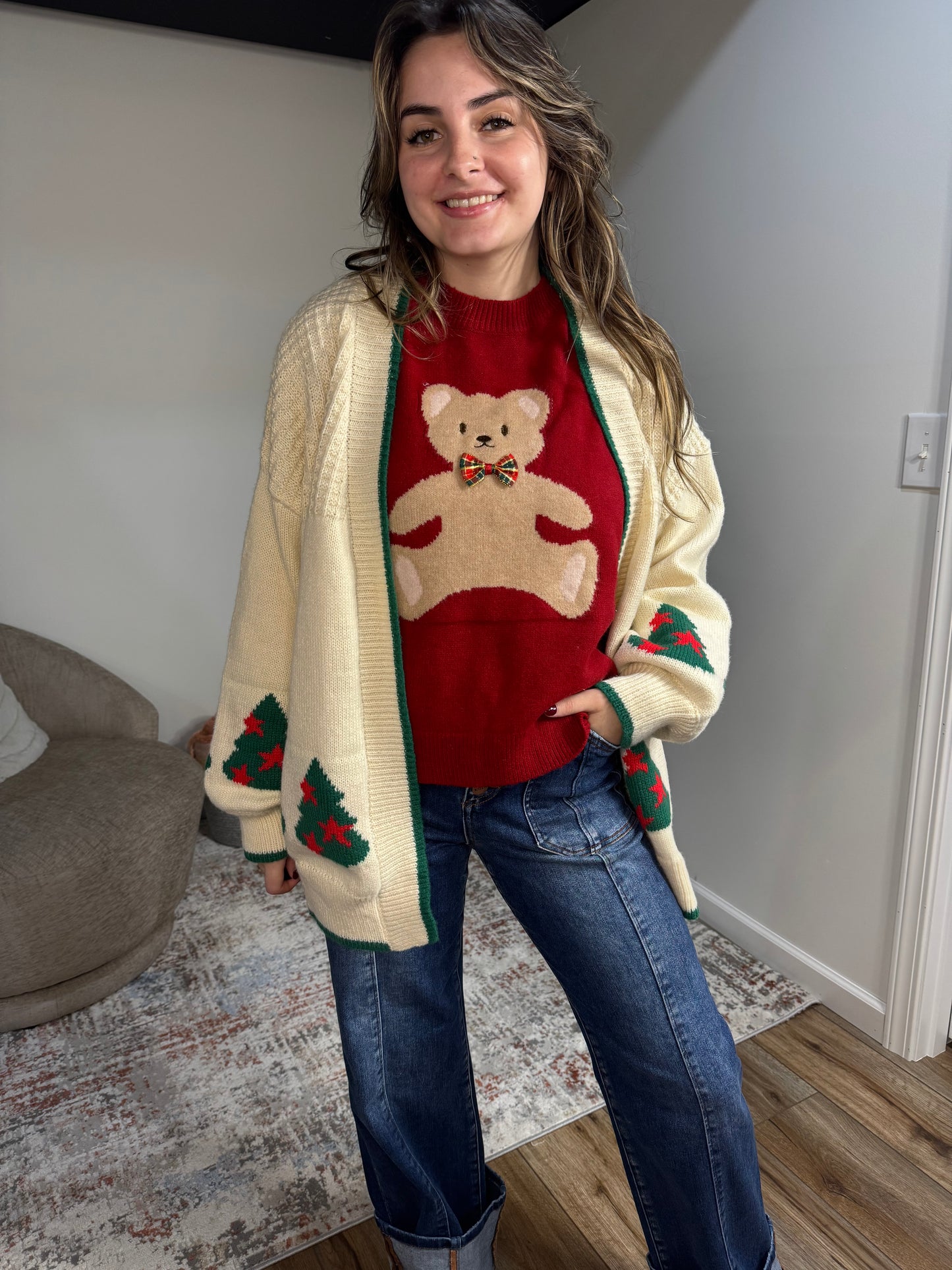 Person wearing a festive sweater with a teddy bear christmas design 