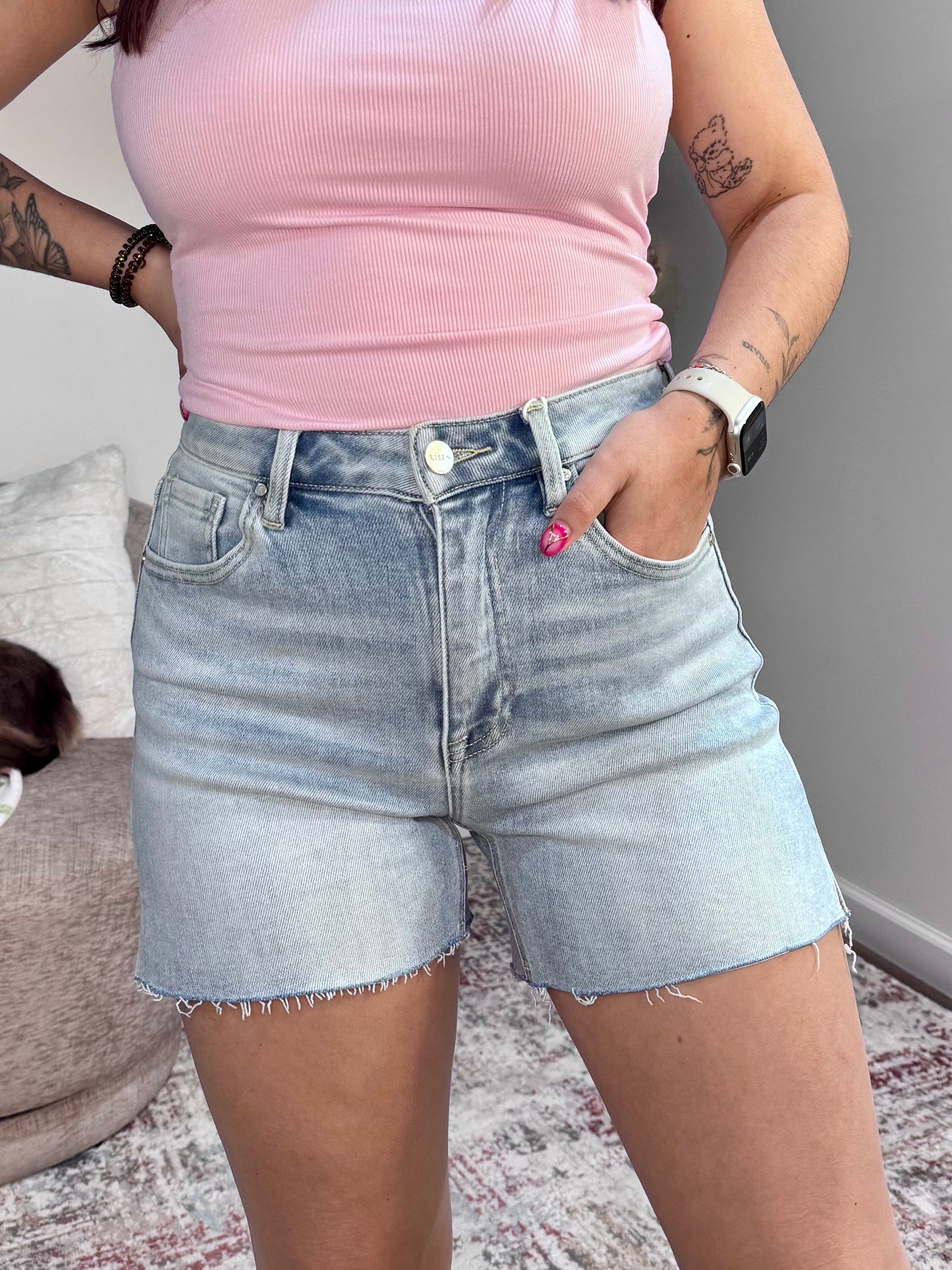 High rise denim shorts with raw hem and side slits. Light wash, stretchy,
