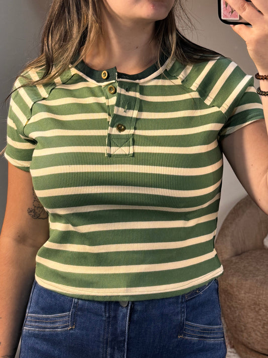 Person wearing a green and white striped shirt taking a selfie.