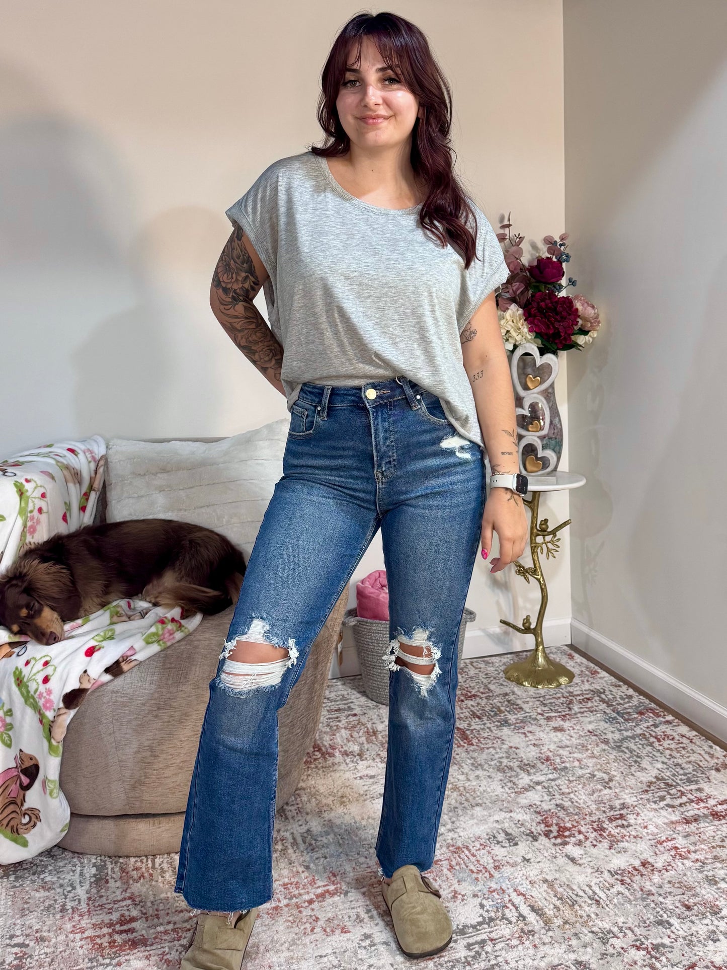 High rise straight leg jeans with knee distressing and raw hem. Stretch denim