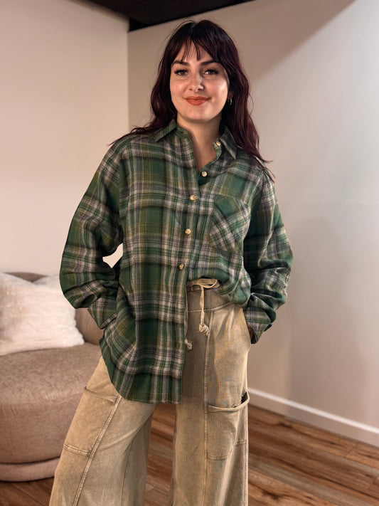 Green plaid flannel shirt with a relaxed fit, worn by a model.
