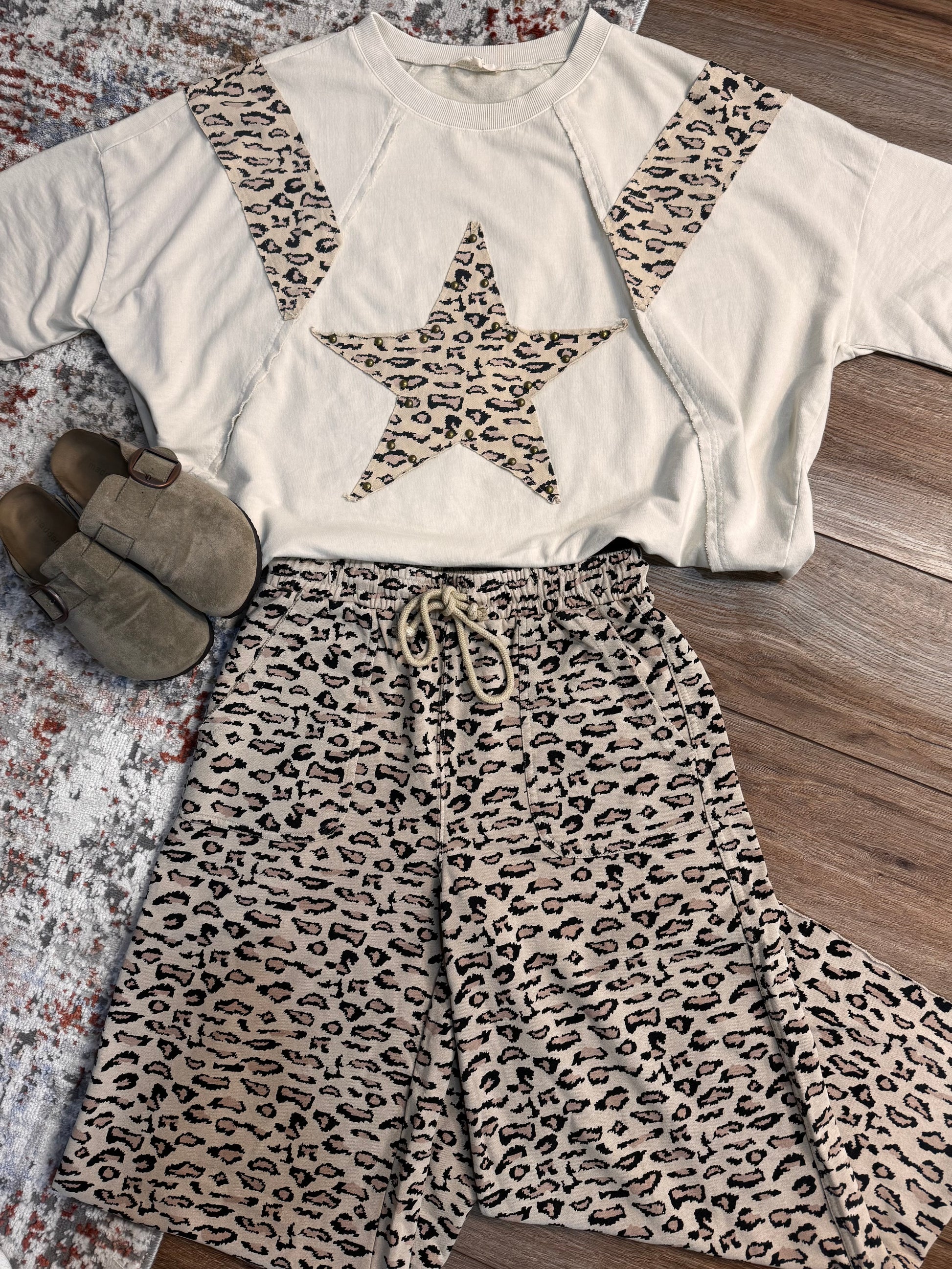 Leopard print outfit with a star design on a white top and matching pants