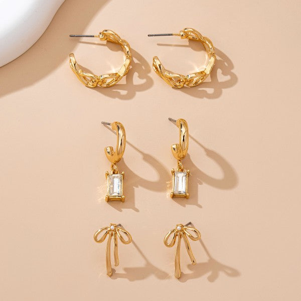 bow earring set, gold huggie earrings with charms, baguette crystal earrings, cute dainty earring sets, and trendy ear stack sets