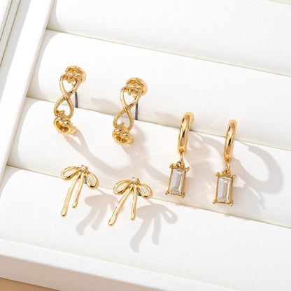 bow earring set, gold huggie earrings with charms, baguette crystal earrings, cute dainty earring sets, and trendy ear stack sets
