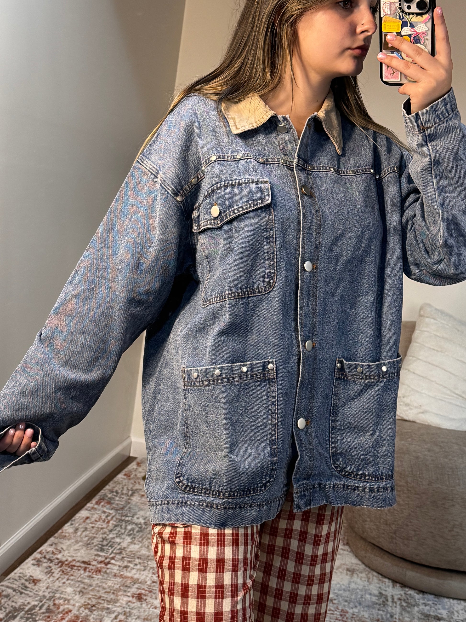 Person wearing a blue denim jacket in an indoor setting