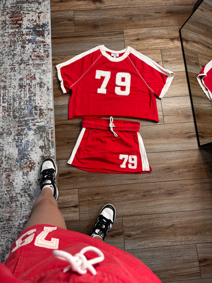 Red sports outfit with number 79 on a wooden floor